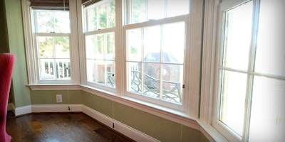 Light green walls, large bay window in dining room looking out on the deck - Residential painting