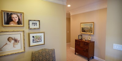 Light tan, taupe, living area with hallway, white trim, crown molding, carpeted floors