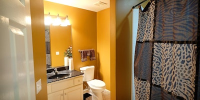 Gold / yellow walls, black and white bathroom vanity and animal print accessories