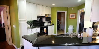 Green and white kitchen with black countertops - Residential painting by Nash Painting Nashville TN